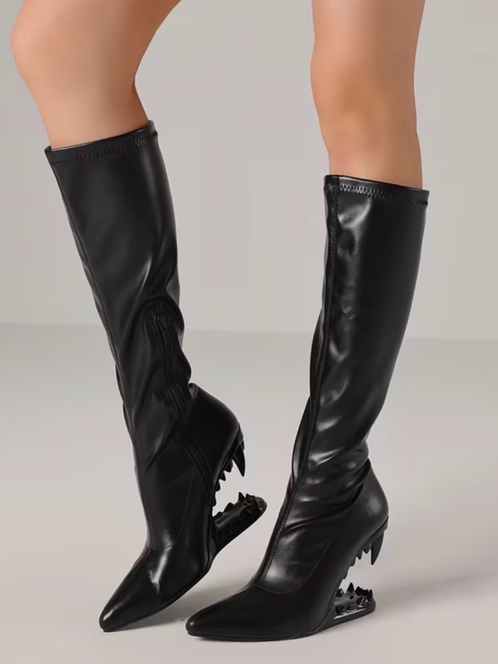 Pointed Knee-High Black Heeled Boots with Sculptural Cutout Wedge